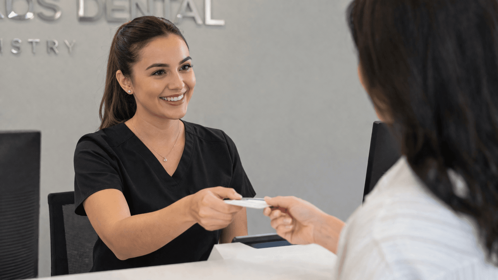Dental receptionist greeting a patient